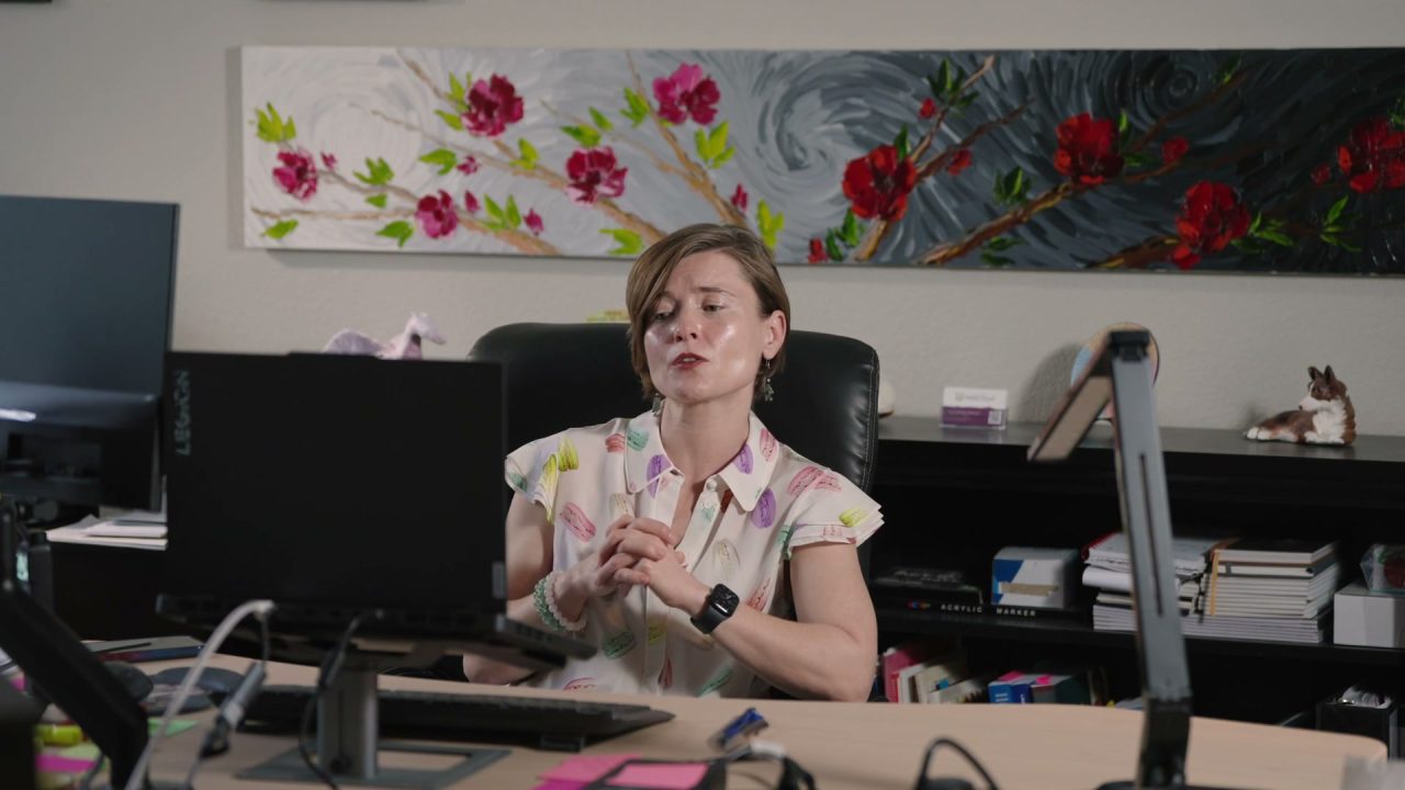 Masha speaking to the camera from her office chair
